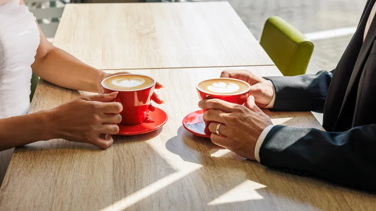Two people drinking coffee